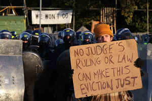 An activist holds up a placard in front of a police line during evictions (Dale Farm, UK, 19 10 2011)(Peter Macdiarmid-Getty Images)